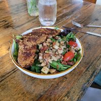 Southern-Terranean--Grilled protein over baby greens and quinoa tossed with marinated cucumbers and cherry tomatoes, capers, spiced chickpeas, sweet onions, and herb feta, finished at The Floridian in St Augustine