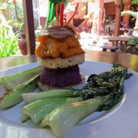 Tower of Power (stack of grilled jicama, mashed purple sweet potatoes, grilled pineapple, ginger mashed pumpkin topped with grilled onion and served with local greens) at Soma Cafe in Ubud