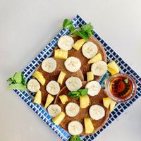 Whole foods banana pancakes with pineapple, sliced banana, mint and maple syrup 😍 at REVIV in Malaga