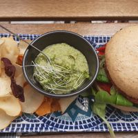 burger with guacamole and vegetable chips at REVIV in Malaga