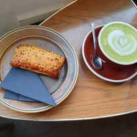 Saucijzenbroodje and matcha latte nicely decorated. at PUCK specialty coffee in Nijmegen