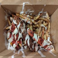 Mixed grill loaded fries (half eaten) at Dhil's in Wigston