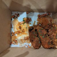 Buffalo wings (half eaten) at Dhil's in Wigston