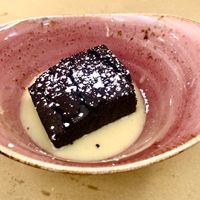 Dark chocolate cake with spiced custard   at Il Rovescio in Bologna