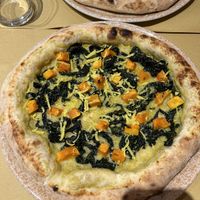 Pizza crema di porri, zucca, cavolo nero, formaggio veg stagionato e olio aromatizzato  at Il Rovescio in Bologna