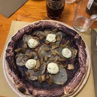 Vegan pizza with radicchio base + potato, mushrooms, vegan cream/cheesee  at Il Rovescio in Bologna