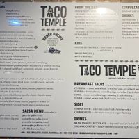 Menu on the building. (V) is vegan. Nov. 1 2022. at Taco Temple in Asheville