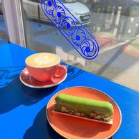 Matcha and apple eclair with a latte. at Eklerownia in Gdansk