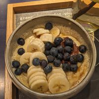 Create your own Porridge: Soja Vanilla Milk + Nougat Creme + blueberries + banana + maple sirup at The Naked Indigo in Salzburg