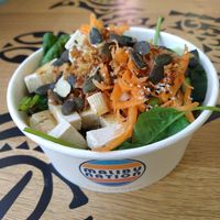 Bowl met rijst, spinazie, tofu, wortel, komkommer, edamame, pompoenpitten, sesamzaad en gebakken uitjes at Malibu Nation in Basel