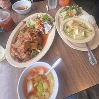 ** lunch orders come with a side salad. We ordered pad sew with mock duck on the left, and green curry with tofu on the right. Ask for vegan   at Thai Elephant of Morro Bay in Morro Bay