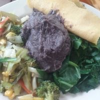 Vegan breakfast sautéed vegetables, bean puree, greens, and handmade tortillas. at Casa de Luz in Austin