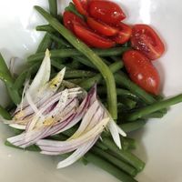 Green collards, tomatoes, and fresh red onion  at Kipling in Turin