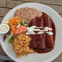 Soyrizo and tofu mole enchiladas with pinto beans, Mexican rice, and salad with vegan ranch at Mr. Natural - East Cesar in Austin