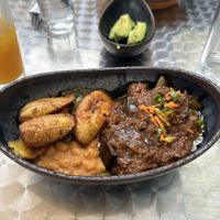 Eggplant stew special with coconut rice, side of creamed spinach and white beans, with plantains💜👍  at Baobab Fare in Detroit