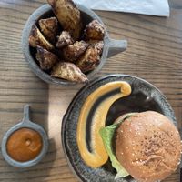 Neat burger w. Potato wedges   at Thalatheen  in Doha