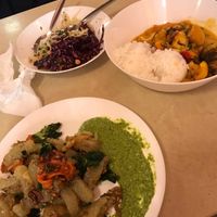 Kind of potato dumplings with pesto, curry + mix of salads  at Zloty Osiol in Katowice