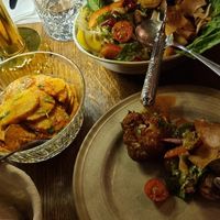 Showing two dishes. One sallad, one potato at Tabbouli - City in Stockholm