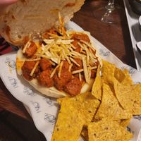 Vegan meatball, vegan cheese, spicy sauce, fried onion sandwhich at Café Bar El Muelle in Santiago De Compostela