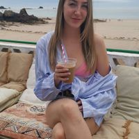 Enjoying my iced coffee with oat milk in Flavour Bay Cafe with view of St Brelades Bay behind me while I waited on my vegan falafel wrap! at Flavour Bay Cafe in Jersey