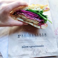 vegan chickpea patty sandwich on focaccia bun at Olive et Gourmando in Montreal