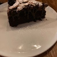 Chocolate chocolate vegan cake with crisp almonds and cherries on top at Brazen Open Kitchen + Bar in Dubuque