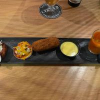 Vegan starter platter: pumpkin burger, mini pizza, vegan croquette, tomato soup at Restaurant Comer in Egmond Aan Zee