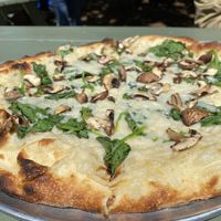 Make your own pizza with garlic sauce, vegan cheese, spinach, and mushrooms   at Sidewall Pizza Company in Bozeman