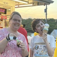 Small peanut butter chocolate sundae on the left, and soft serve blue raspberry/hard serve strawberry banana/vegan whipped cream ALL in a waffle cone on the right  at Skoops Ice Cream in Barberton