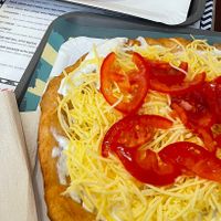Langos with vegan sour cream, vegan cheese and tomatoes   at Retró Lángos Budapest in Budapest