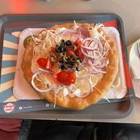 The second option on the menu, with ”yoghurt”, ”cheese”, red onion, tomato, olives, garlicc  at Retró Lángos Budapest in Budapest
