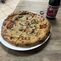 Personal pizza with basil and spinach and a Señorial Sangria soda  at Meek's Vegan Pizza in Houston