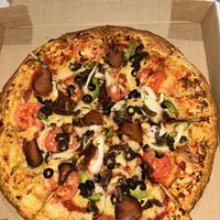 Greek pizza with seitan pepperoni and mushrooms  at Meek's Vegan Pizza in Houston