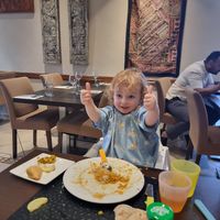 Kids giving the plain curry sauce a thumbs up! at Clay Oven in Albufeira