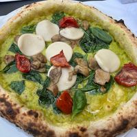 Pizza with creamy zucchini sauce basil sundries tomatoes and mushrooms. And vegan mozzarella  at Organic Pizza & Food in Milan