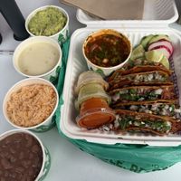Birria tacos, guac, queso, rice, beanss  at Calaveritas in Atlanta