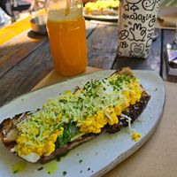 Vegan tofu scramble with mushrooms, spinach vegan cheese on sourdough at Ergon Agora in Thessaloniki