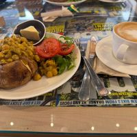 Coronation chickpea filling (fruity and spicy with tikka paste, raisins and mango) and side salad on a baked potato with vegan spread

Flat white coffee with oat milk at 3 Peaks Cycles in Settle