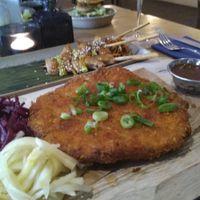 Schnitzel: they cut it at your table with a huge butcher's knife at De Vegetarische Slager - The Vegetarian Butcher in The Hague