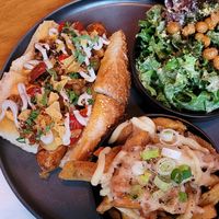 Seitan Hot Dog, side poutine and side caesar salad at Good Dogs Plant Foods in Vancouver