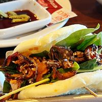 Vegan buns: Steamed buns filled with UMAMI shiitake
mushrooms, sesame seeds, fried onion,
baby mix greens with teriyaki sauce and sesame sauce at Rakkan Ramen in Boulder