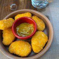Vegan no chicken nuggets with a curry sauce.  at Bar Tomeu in Sitges