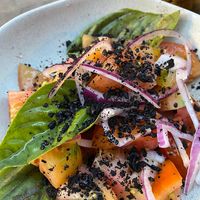 Tomato salad with onions, basil and olive crumble.  at Bar Tomeu in Sitges