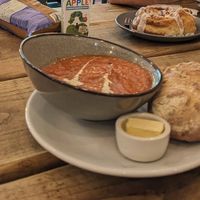 Soup of the day with a cinnamon roll in the background at FRÂN Las in Llanberis