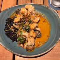 Aloo gobi main (second course) with delicately crisp cauliflower and marble potatoes, coconut purple rice, and curry sauce at Beach House by Roy Yamaguchi in Kahuku
