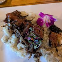steak on mashed potatoes and gravy at COMMUNITY Kitchen + Taproom in Austin