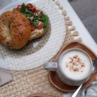 Hummus bagel, chai latte at Biomio Brunch Ecológico in Sevilla