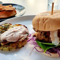 These are Oyster Mushrooms lightly breaded and fried, stacked like a  Burger with a smashed potato herb garlic cake & side of Roasted Sweet Potato Wedges with an herbed dairy free dipping aioli sauce at Christopher's Kitchen in Palm Beach Gardens