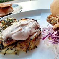 Oyster Mushroom Burger with a smashed potato herb garlic cake & side of Roasted Sweet Potato Wedges with an herbed  dairy free dipping aioli sauce at Christopher's Kitchen in Palm Beach Gardens