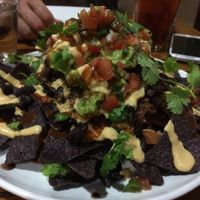 Vegan stacked nachos. Really nice size portion of nachos with vegan cheese, beans, rice, guac, etc. at Christopher's Kitchen in Palm Beach Gardens
